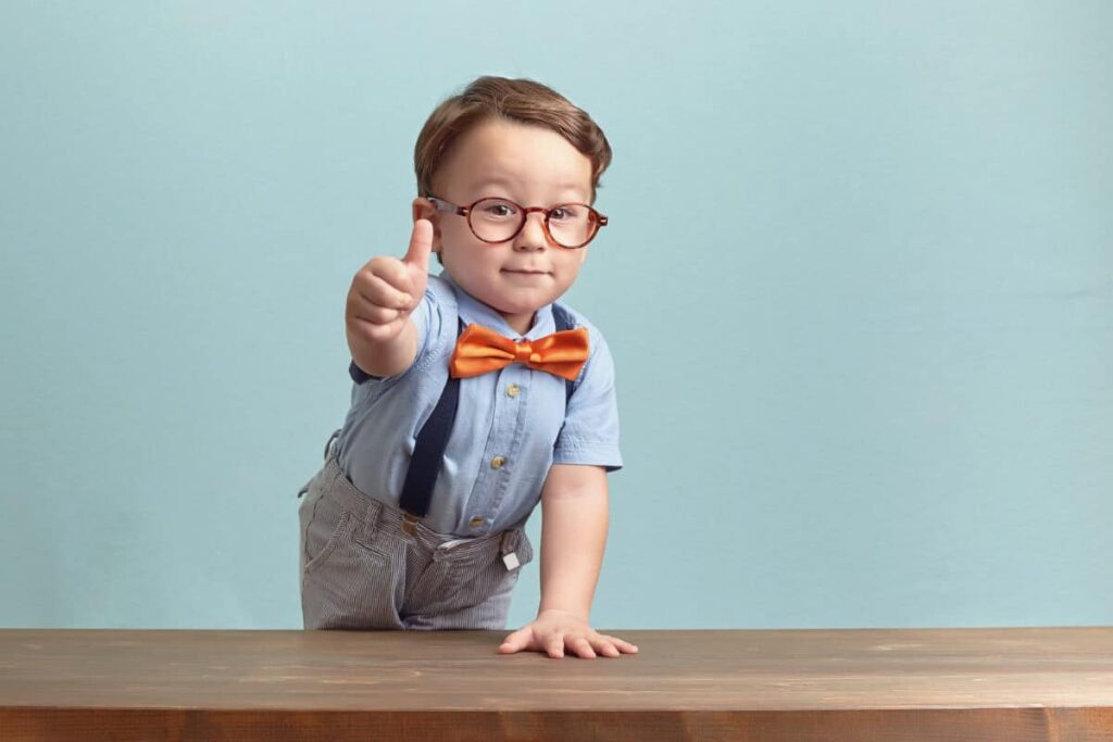 2 Slam-Dunk Dividend Stocks to Buy Now boy in bowtie and glasses gives positive thumbs up